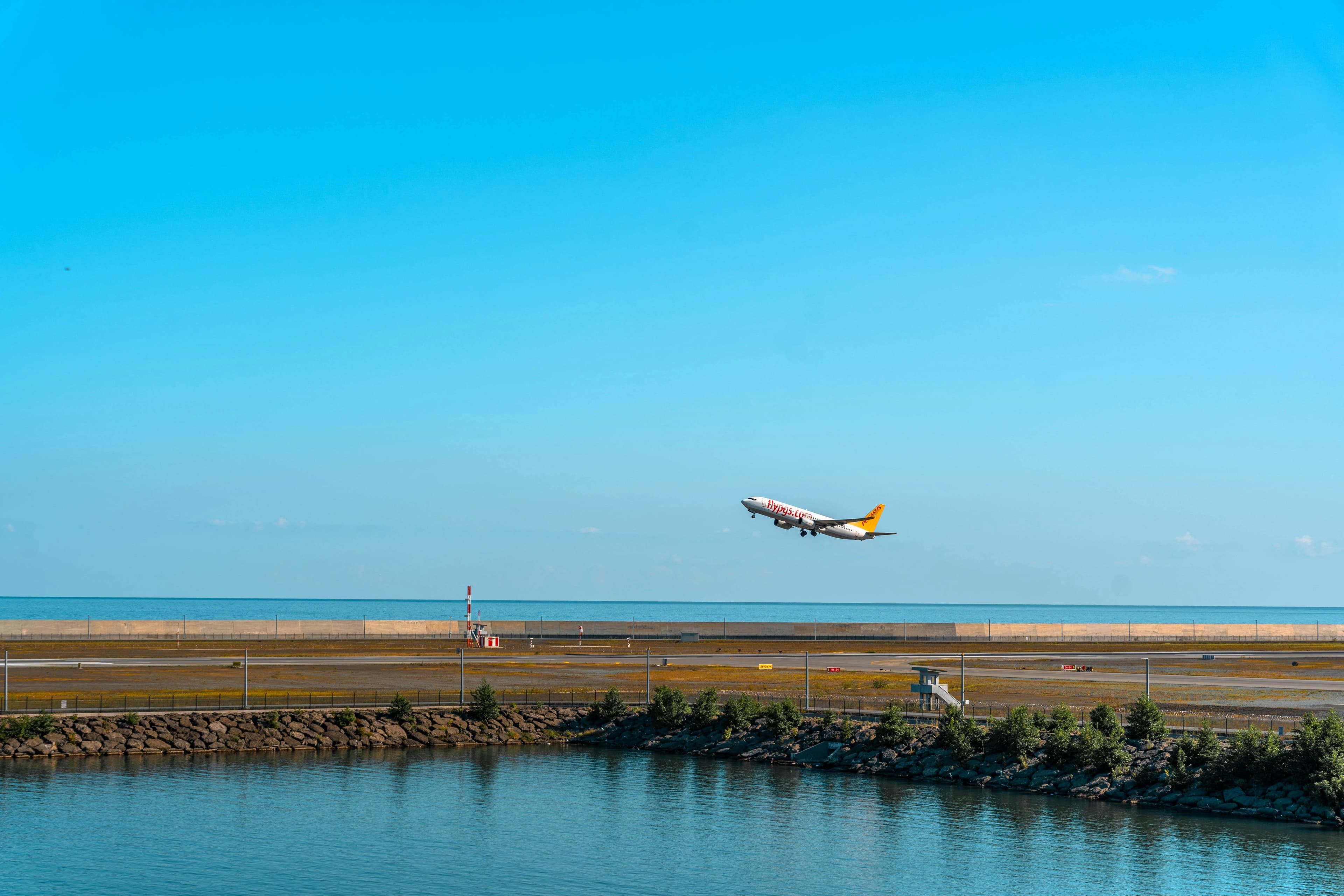 Plane taking off at sunset — photo by Eren Arici